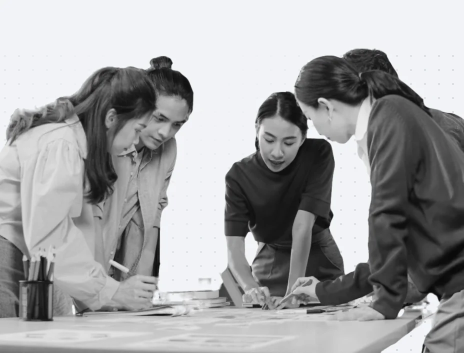 A team of experts brainstorming digital strategies on a whiteboard.